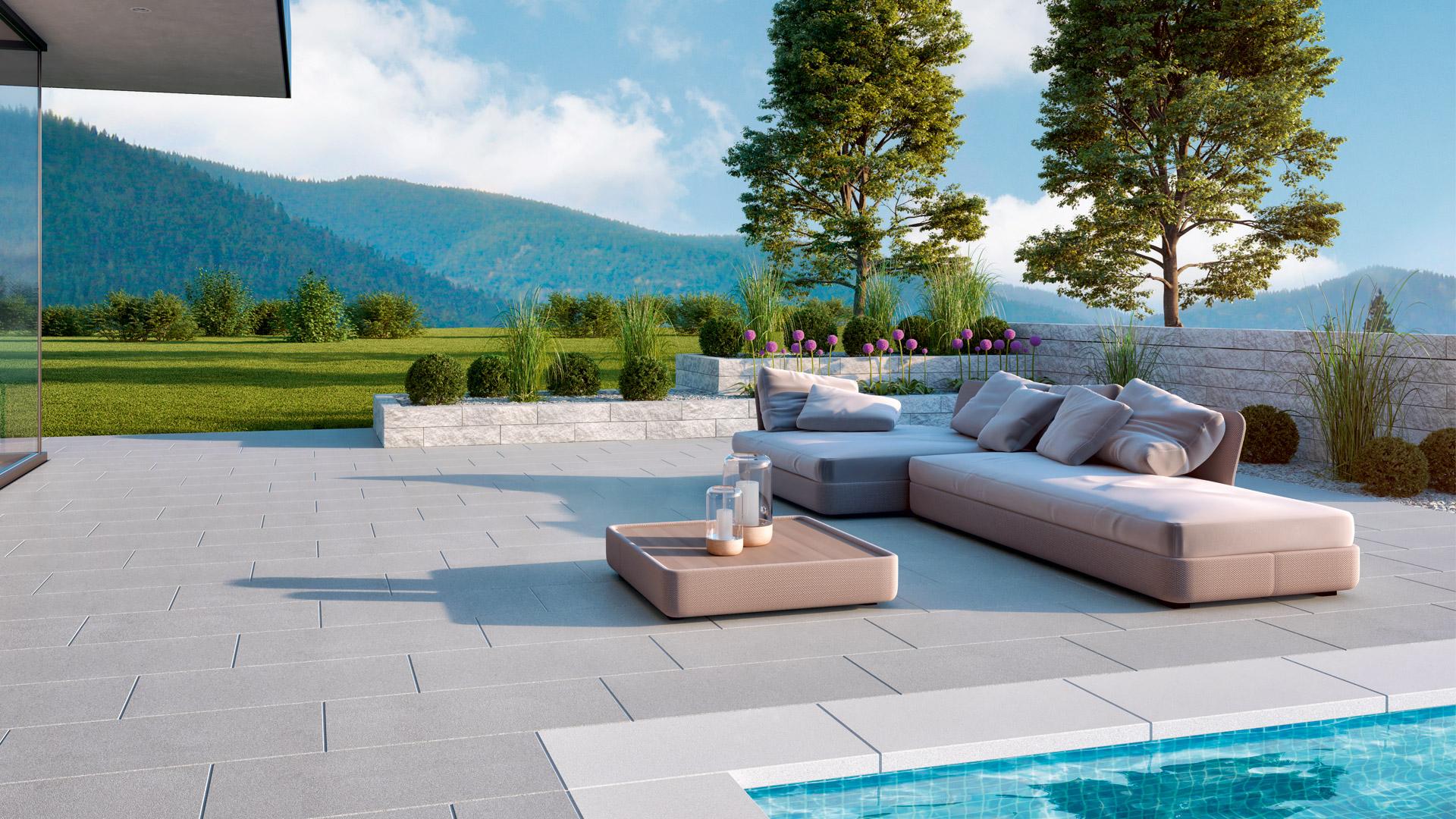 Moderne Gartengestaltung mit Terrassenplatten und Hochbeeten von Friedl Steinwerke und einem Pool